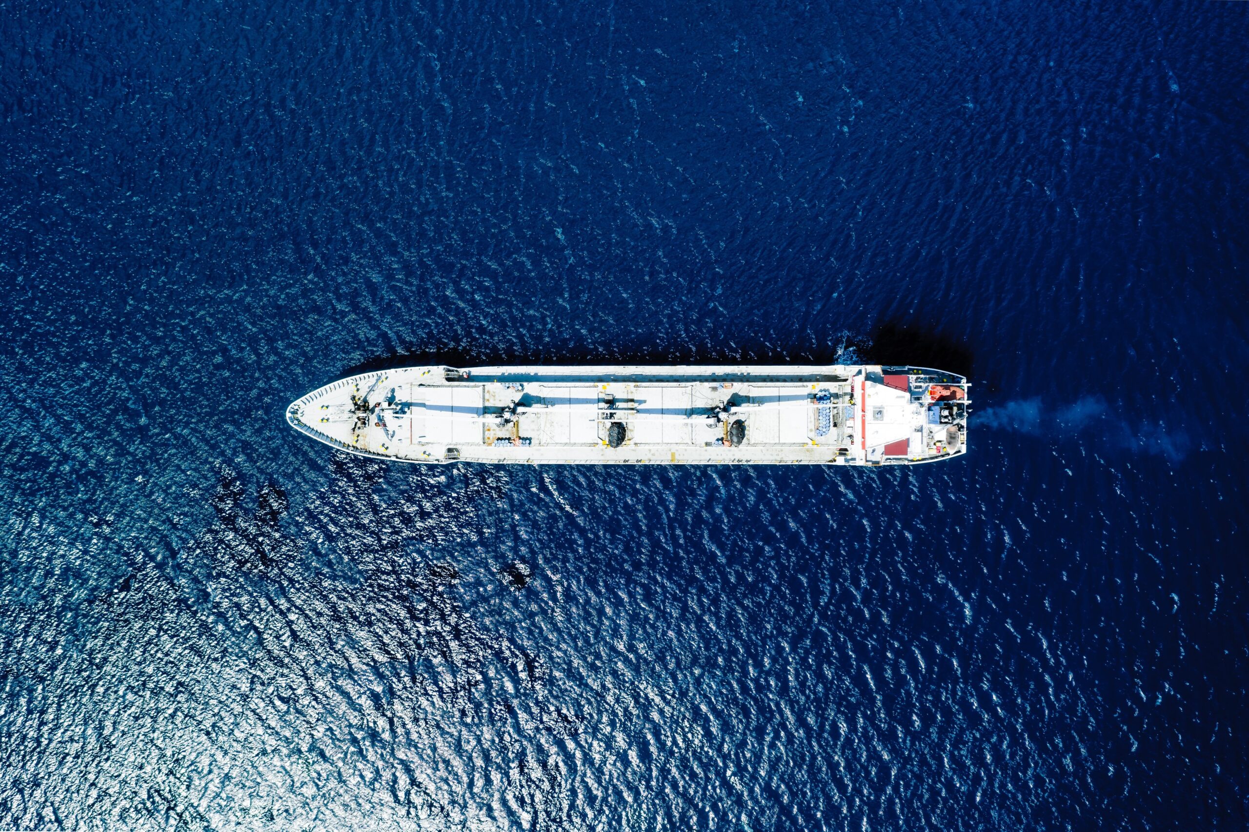 An aerial view of a blue sea and a boat